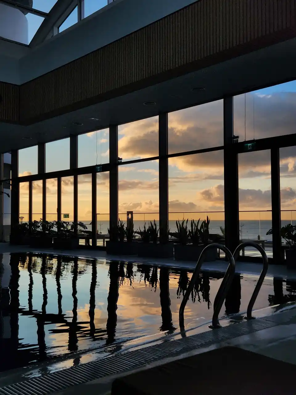 Serene indoor pool sunset view